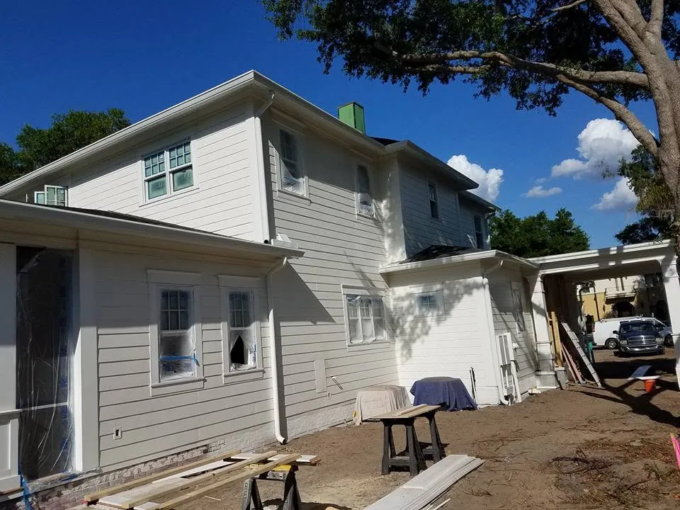 Gray lap siding two story renovation white downspout sawhorses oak, Sanford